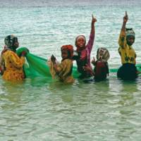 Local women celebrate a successful fishing expedition | Christa Cameron
