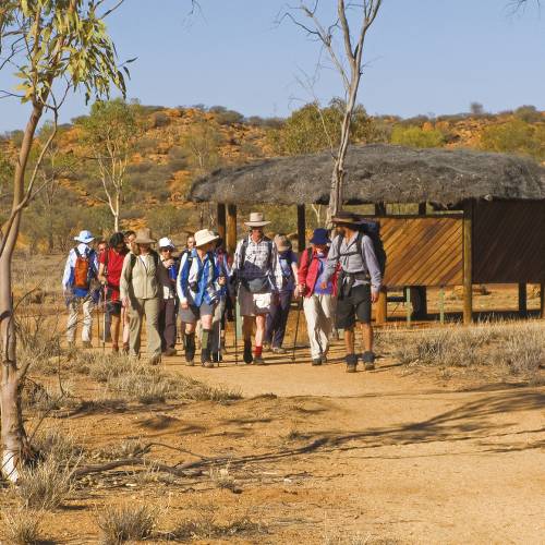 Trekkers embarking at the beginning of the Larapinta Trail, the old Telegraph Station