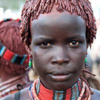 A Hamer tribe member in traditional colourful dress | Amber Hooper