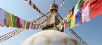 Prayer flags hang from the Boudhanath stupa in Kathmandu | Ayla Rowe